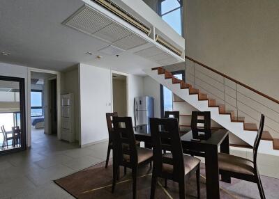 Modern dining area in a duplex with staircase