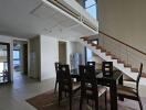 Modern dining area in a duplex with staircase