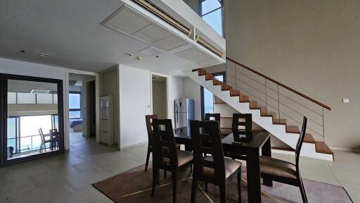 Modern dining area in a duplex with staircase