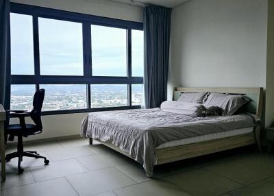 Modern bedroom with large windows and city view