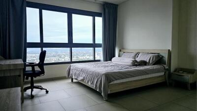 Modern bedroom with large windows and city view