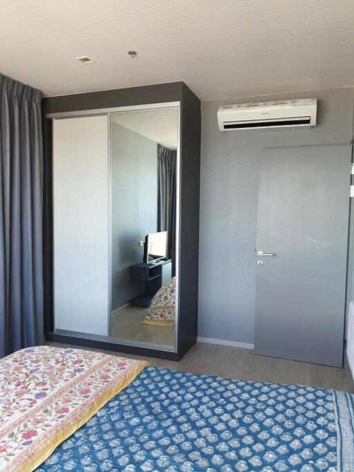 Bedroom with large mirrored wardrobe and air conditioning unit