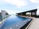 Rooftop pool with lounge area and scenic view