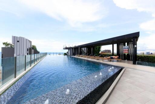 Rooftop pool with lounge area and scenic view