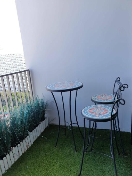 Balcony with a small table and chairs