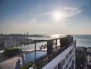 Modern high-rise building with rooftop pool and scenic cityscape view