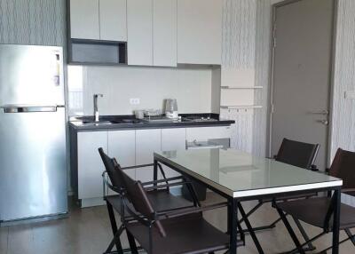 Modern kitchen and dining area with a glass table