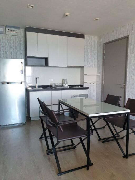 Modern kitchen and dining area with a glass table