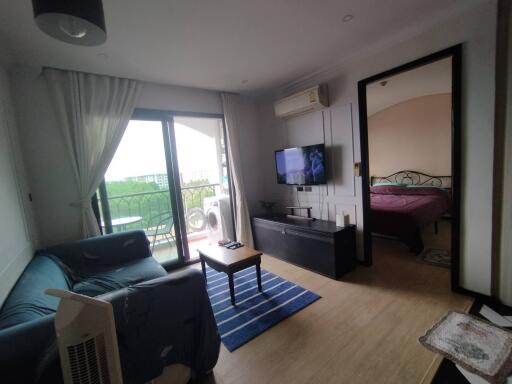 Living room with a view of the bedroom and balcony