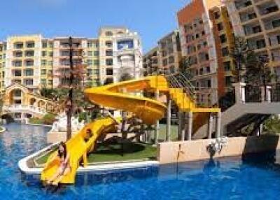 Exterior view of apartment complex with pool and water slide