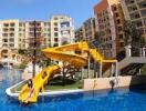 Exterior view of apartment complex with pool and water slide