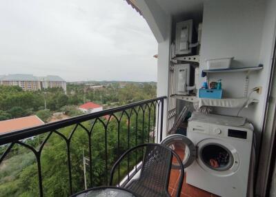 Balcony with washing machine and outdoor view