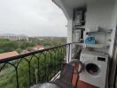 Balcony with washing machine and outdoor view