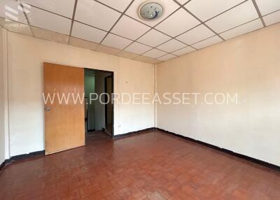 Empty room with tiled ceiling and wooden floor