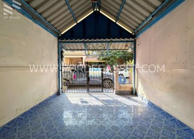 Garage with blue patterned floor tiles and metal roof