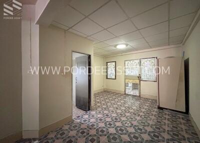 Living room with tiled flooring and window bars