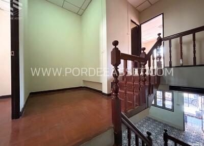 Interior staircase landing with wooden rails