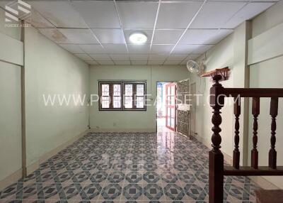 Spacious living room with tiled floor and ample natural light