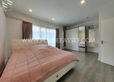 Spacious bedroom with large bed and wardrobe