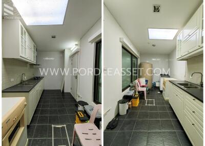 Modern white kitchen with dark tiled floor