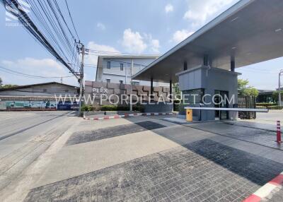 Exterior view of a residential building and entrance gate