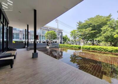 View of modern building with porch and reflection pool