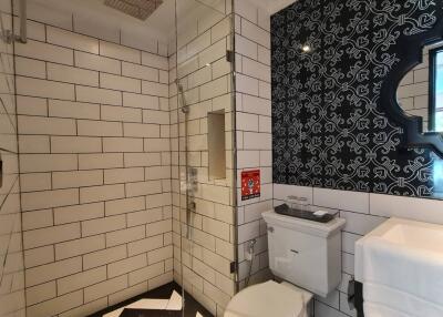 Modern bathroom with tiled walls and shower