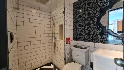 Modern bathroom with tiled walls and shower