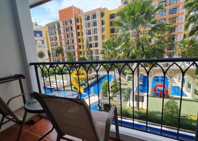 Balcony view overlooking pool and colorful buildings