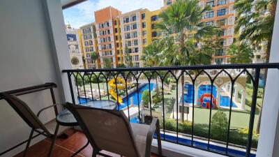 Balcony view overlooking pool and colorful buildings