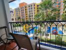 Balcony view overlooking pool and colorful buildings