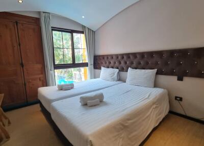 Well-lit bedroom with two single beds