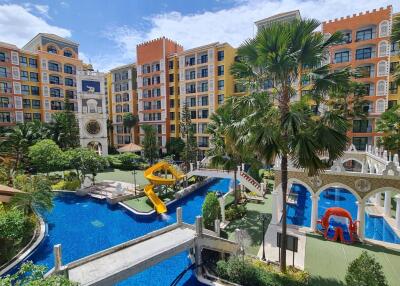 Exterior view of residential complex with pool and playground