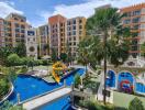 Exterior view of residential complex with pool and playground