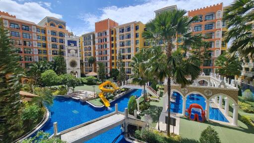 Exterior view of residential complex with pool and playground