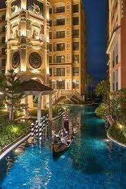 Night view of illuminated building exterior with canal and gondola