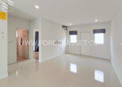 Spacious living room with bright white tiles