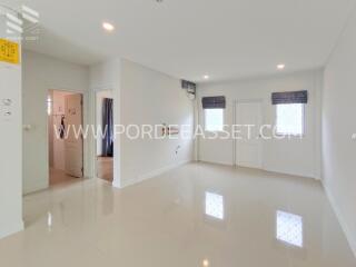 Spacious living room with bright white tiles