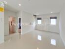 Spacious living room with bright white tiles