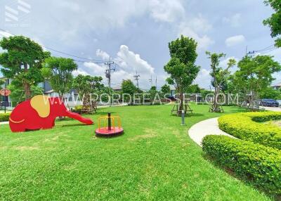 Community playground with green grass and playground equipment