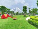 Community playground with green grass and playground equipment