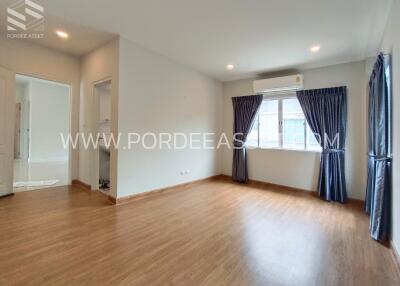 Spacious living room with wooden flooring and large windows