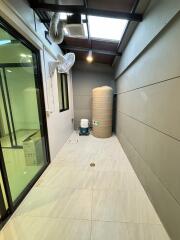 Well-lit utility room with storage tank and ductwork