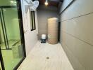 Well-lit utility room with storage tank and ductwork