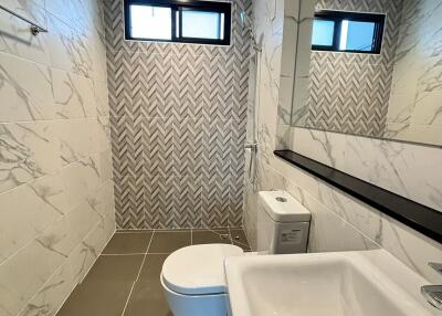 Modern bathroom with marble design and large mirror