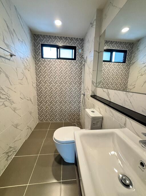 Modern bathroom with marble design and large mirror