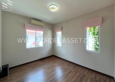 Well-lit room with wooden flooring