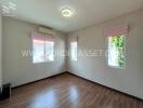 Well-lit room with wooden flooring