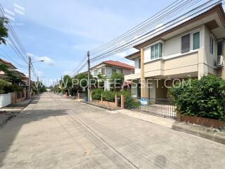 A street view of modern residential houses with clear skies