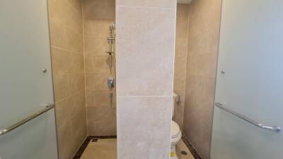 Modern bathroom with partitions and neutral tiles